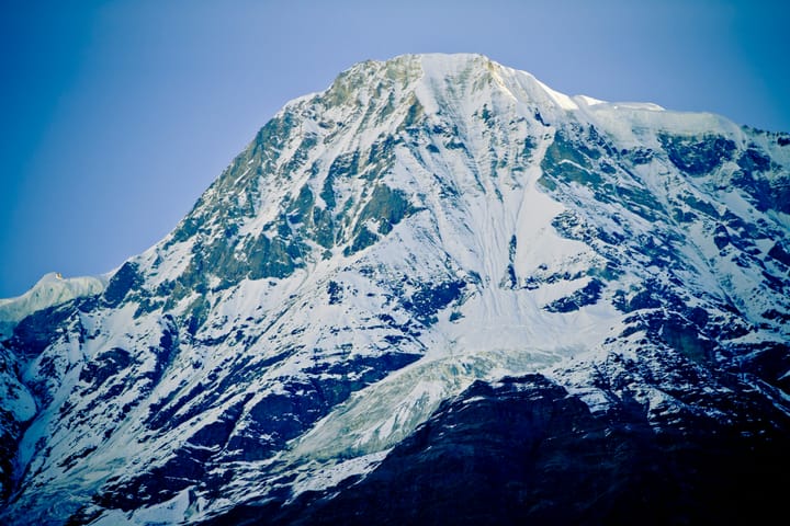 What has roots as nobody sees, Is taller than trees, Up, up it goes, And yet never grows?